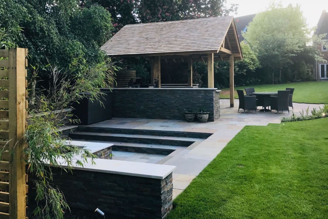 Sunken fire pit and entertaining area in garden